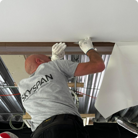 Skyspan installateurs plaatsen een spanplafond